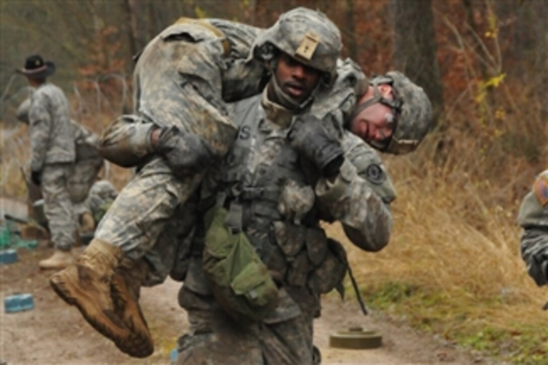 U.S. Army Sgt. Andre Lobban carries a simulated casualty through a simulated minefield during training at Rose Barracks, Germany, on Nov. 28, 2012.  Lobban is attached to Palehorse Troop, 4th Squadron, 2nd Cavalry Regiment.  