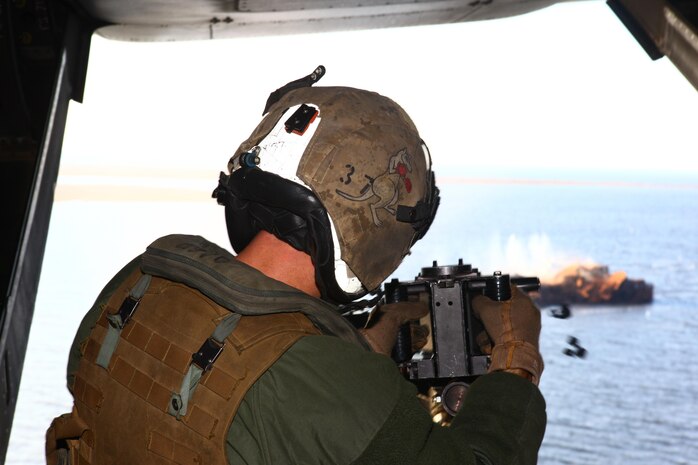 Staff Sgt. Rodney McDowall, Marine Medium Tiltrotor Squadron 266 MV-22B Osprey crew chief, fires the GAU-16 .50-caliber heavy-machine gun at a target from the ramp of the Osprey while conducting a live-fire gun shoot, Nov. 28.