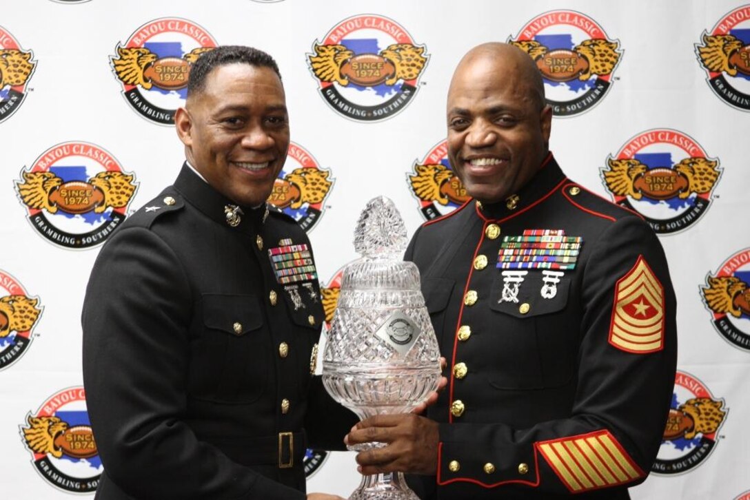 Brig. General Craig Crenshaw holds the Bayou Classic Championship trophy with Sgt. Major Michael Logan at the Bayou Classic, held each year on Thanksgiving Day at the Mercedes-Benze Superdome, New Orleans, La.