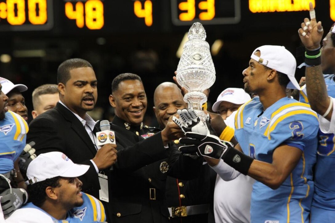 Brig. General Craig Crenshaw and Sgt. Major Michael Logan present the Bayou Classic Championship trophy to the players of Southern University, the winners of the 39th Annual Bayou Classic.