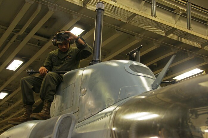 Lance Cpl. Ramon Sapien, a Dallas, native and AH-1W Super Cobra mechanic with Marine Medium Tiltrotor Squadron 261 (Reinforced), 24th Marine Expeditionary Unit, prepares for the installment of a main rotor to an AH-1W Super Cobra aboard USS Iwo Jima, Dec. 3, 2012. The 24th MEU is deployed with the Iwo Jima Amphibious Ready Group and is currently in the 6th Fleet area of responsibility. Since deploying in March, they have supported a variety of missions in the U.S. Central, Africa and European Commands, assisted the Navy in safeguarding sea lanes, and conducted various bilateral and unilateral training events in several countries in the Middle East and Africa. The Cobras, along with UH-1N Hueys, make up the "Skid" detachment for VMM-261 (Rein) and are originally from Marine Light Attack Helicopter Squadron 269, based at Marine Corps Air Station New River, N.C. (U.S. Marine Corps photo by Lance Cpl. Tucker S. Wolf/Released)