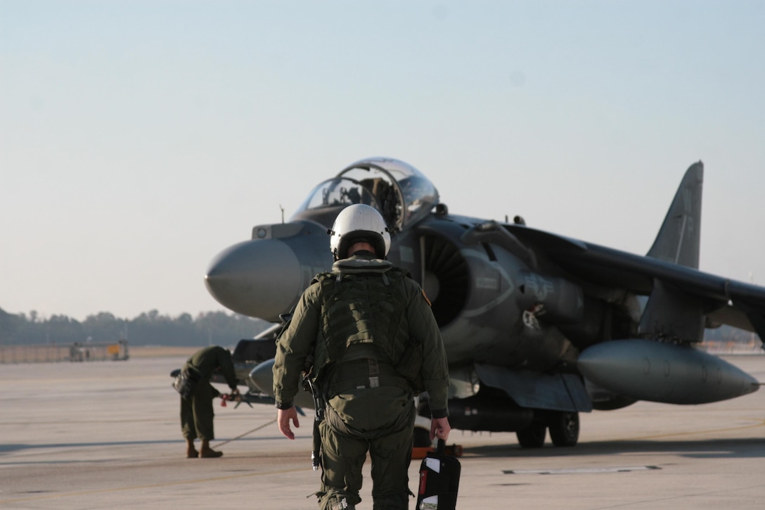 Capt. Alexander M. Mellman, the operations officer for Marine Fixed Wing Attack Squadron 223, walks towards his Harrier during a training exercise at Cherry Point on November 28, 2012. Mellman is a weapons training officer who was involved with the training of four new WTOs.


