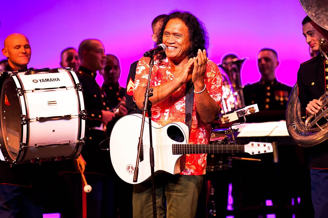 Henry Kapono, Grammy nominated singer and songwriter, performs alongside the U.S. Marine Corps Forces, Pacific Band at the Na Mele o na Keiki (Music for the Children) Holiday concert here Dec. 2. The concert was an opportunity to receive donations for the U.S. Marine Corps Forces, Reserve nationwide “Toys for Tots” donation program to provide gifts for the less-fortunate children in the U.S.