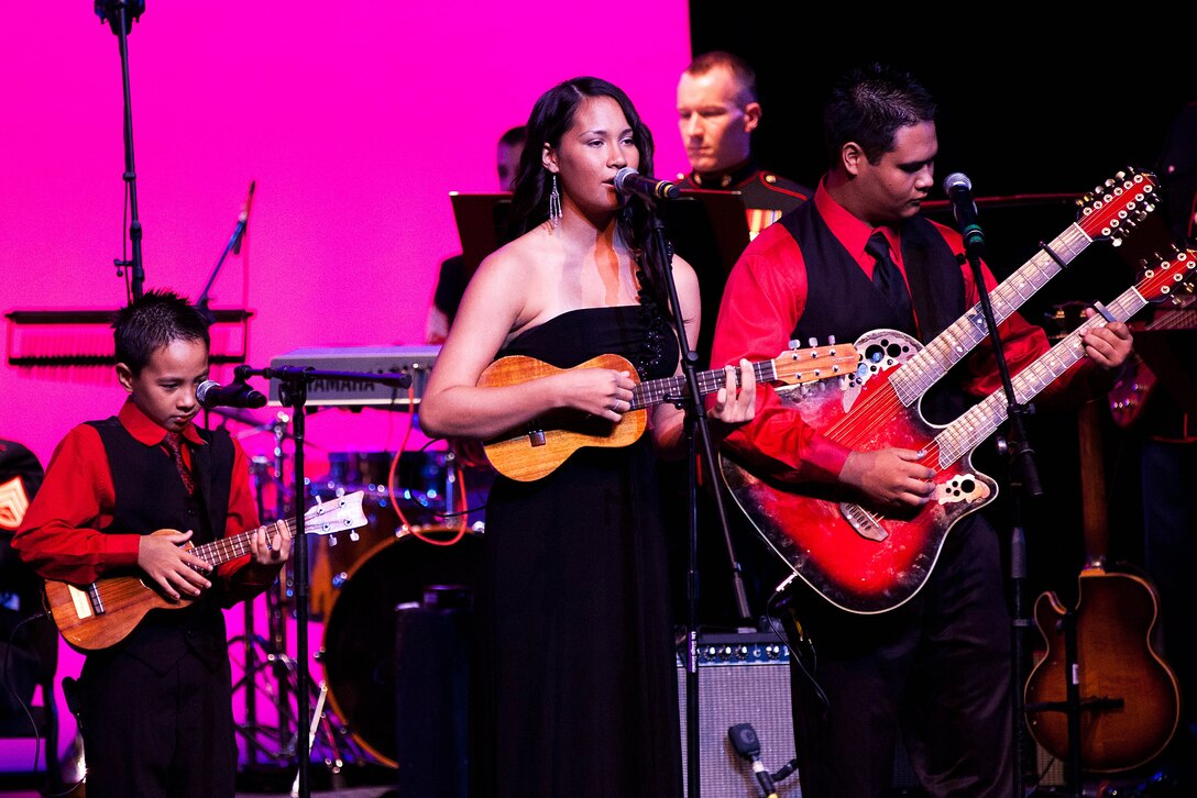The Abrigo ‘Ohana, a traditional Hawaiian music band, performs alongside the U.S. Marine Corps Forces, Pacific Band, at the Na Mele o na Keiki (Music for the Children) Holiday concert here Dec. 2. The concert was an opportunity to receive donations for the U.S. Marine Corps Forces, Reserve nationwide “Toys for Tots” donation program to provide gifts for the less-fortunate children in the U.S.