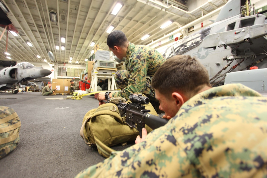 USS IWO JIMA, Mediterranean Sea (Dec. 4, 2012) - Marines with Bravo Company, Battalion Landing Team 1st Battalion, 2nd Marine Regiment, 24th Marine Expeditionary Unit, laser bore sight their weapon systems aboard  USS Iwo Jima, Dec.4, 2012. Laser bore sighting is used to ensure that the alignment of the AN/PEQ-16A pointer illuminator aiming flashlight and the M16A4 service rifle are calibrated together correctly. The 24th MEU is deployed with the Iwo Jima Amphibious Ready Group and is currently in the 6th Fleet area of responsibility. Since deploying in March, they have supported a variety of missions in the U.S. Central, Africa and European Commands, assisted the Navy in safeguarding sea lanes, and conducted various bilateral and unilateral training events in several countries in the Middle East and Africa. (U.S. Marine Corps photo by Lance Cpl. Tucker S. Wolf/Released)