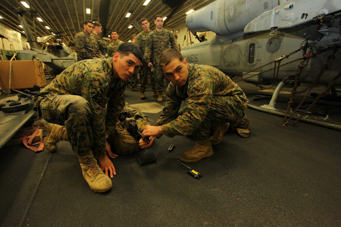 USS IWO JIMA, Mediterranean Sea (Dec. 4, 2012) - Cpl. Jairo Triana(left), a Miami, Fla., native and Cpl. Timothy Jones(right), a Warwick, N.Y., native both with Bravo Company, Battalion Landing Team 1st Battalion, 2nd Marine Regiment, 24th Marine Expeditionary Unit, laser bore sight their weapon systems aboard  USS Iwo Jima, Dec.4, 2012. Laser bore sighting is used to ensure that the alignment of the AN/PEQ-16A pointer illuminator aiming flashlight and the M16A4 service rifle are calibrated together correctly. The 24th MEU is deployed with the Iwo Jima Amphibious Ready Group and is currently in the 6th Fleet area of responsibility. Since deploying in March, they have supported a variety of missions in the U.S. Central, Africa and European Commands, assisted the Navy in safeguarding sea lanes, and conducted various bilateral and unilateral training events in several countries in the Middle East and Africa. (U.S. Marine Corps photo by Lance Cpl. Tucker S. Wolf/Released)