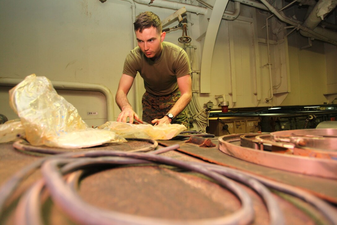 USS IWO JIMA, Mediterranean Sea (Dec. 5, 2012) - Sgt. Joseph Pearce, a Richmond, Va., native and tank gunner with Tank Platoon, Weapons Company, Battalion Landing Team 1st Battalion, 2nd Marine Regiment, 24th Marine Expeditionary Unit, prepares for maintenance checks on an M1A1 Abrams tank aboard USS Iwo Jima, Dec. 5, 2012. The 24th MEU is deployed with the Iwo Jima Amphibious Ready Group and is currently in the 6th Fleet area of responsibility. Since deploying in March, they have supported a variety of missions in the U.S. Central, Africa and European Commands, assisted the Navy in safeguarding sea lanes, and conducted various bilateral and unilateral training events in several countries in the Middle East and Africa. (U.S. Marine Corps photo by Lance Cpl. Tucker S. Wolf/Released)
