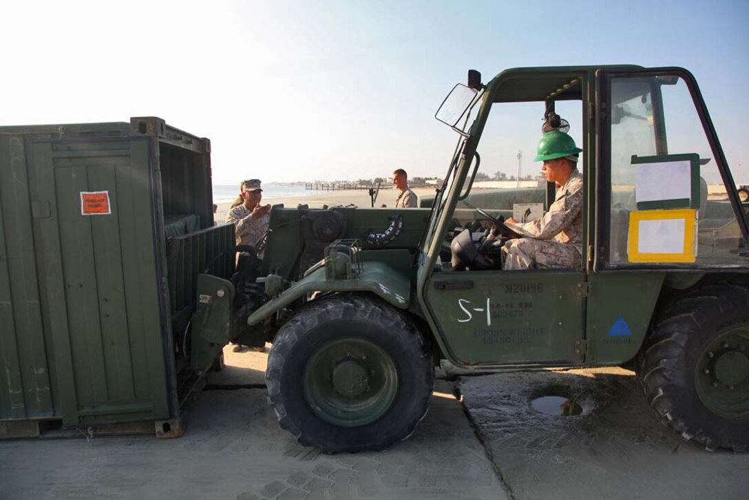 Marines assigned to Combat Logistics Battalion 15, 15th Marine Expeditionary Unit, unload a Light-Weight Water Purification System to function-test the equipment at Camp Patriot, Kuwait, Nov. 28. The Marines recently completed Eager Mace 13, a routine training exercise that focused on promoting regional security, stability and mutual interests in the region. The 15th MEU is deployed as part of the Peleliu Amphibious Ready Group as a U.S. Central Command theater reserve force, providing support for maritime security operations and theater security cooperation efforts in the U.S. 5th Fleet area of responsibility. (U.S. Marine Corps photo by Cpl. Timothy R. Childers)