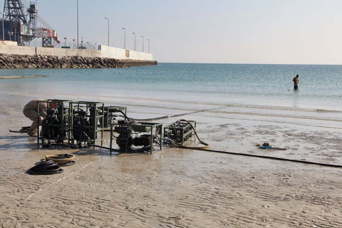 Lance Cpl. Saul Sanchez, water support technician, Engineer Detachment, Combat Logistics Battalion 15, 15th Marine Expeditionary Unit, drags the intake valve of a Light-Weight Water Purification System into the ocean to function-test the equipment at Camp Patriot, Kuwait, Nov. 28. The Marines recently completed Eager Mace 13, a routine training exercise that focused on promoting regional security, stability and mutual interests in the region. The 15th MEU is deployed as part of the Peleliu Amphibious Ready Group as a U.S. Central Command theater reserve force, providing support for maritime security operations and theater security cooperation efforts in the U.S. 5th Fleet area of responsibility. Sanchez, 21, is from Norwalk, Calif. (U.S. Marine Corps photo by Cpl. Timothy R. Childers)