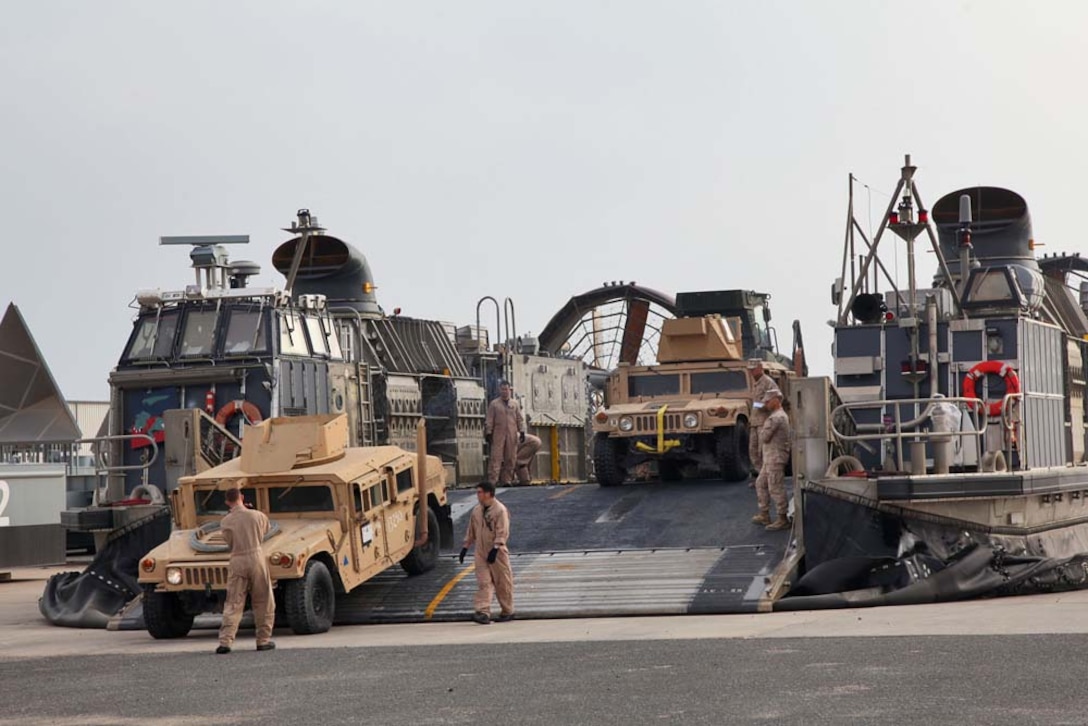 Sailors assigned to the USS Rushmore guide a Humvee onto a Landing Craft Air Cushion to tranpsort Marines from the 15th Marine Expeditionary Unit and cargo from Camp Patriot, Kuwait, to the USS Rushmore on Nov. 29. The Marines recently completed Eager Mace 13, a routine training exercise that focused on promoting regional security, stability and mutual interests in the region. The 15th MEU is deployed as part of the Peleliu Amphibious Ready Group as a U.S. Central Command theater reserve force, providing support for maritime security operations and theater security cooperation efforts in the U.S. 5th Fleet area of responsibility.  (U.S. Marine Corps photo by Cpl. Timothy R. Childers)