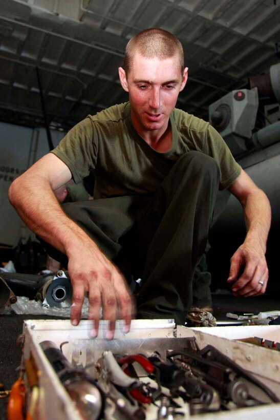 Lance Cpl. Jack R. Dunworth, CH-53E Super Stallion mechanic, Marine Medium Helicopter Squadron 364 (Rein.), 15th Marine Expeditionary Unit, puts tools away after performing maintenance on a helicopter in the hangar bay of the USS Peleliu, Nov. 29. The 15th MEU is deployed as part of the Peleliu Amphibious Ready Group as a U.S. Central Command theater reserve force, providing support for maritime security operations and theater security cooperation efforts in the U.S. 5th Fleet area of responsibility. Dunworth, 23, is from Ft. Lauderdale, Fla. (U.S. Marine Corps photo by Cpl. John Robbart III/Released)