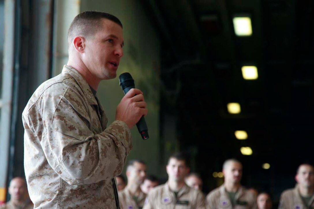 Lieutenant Col. Ned M. Biehl, commanding officer, Marine Medium Helicopter Squadron 364 (Rein.), 15th Marine Expeditionary Unit, addresses his unit after a squadron promotion and awards ceremony in the hangar bay of the USS Peleliu, Dec. 1. Marine Medium Helicopter Squadron 364 (Rein.) serves as the aviation combat element for the 15th MEU. The 15th MEU is deployed as part of the Peleliu Amphibious Ready Group as a U.S. Central Command theater reserve force, providing support for maritime security operations and theater security cooperation efforts in the U.S. 5th Fleet area of responsibility. (U.S. Marine Corps photo by Cpl. John Robbart III/Released)
