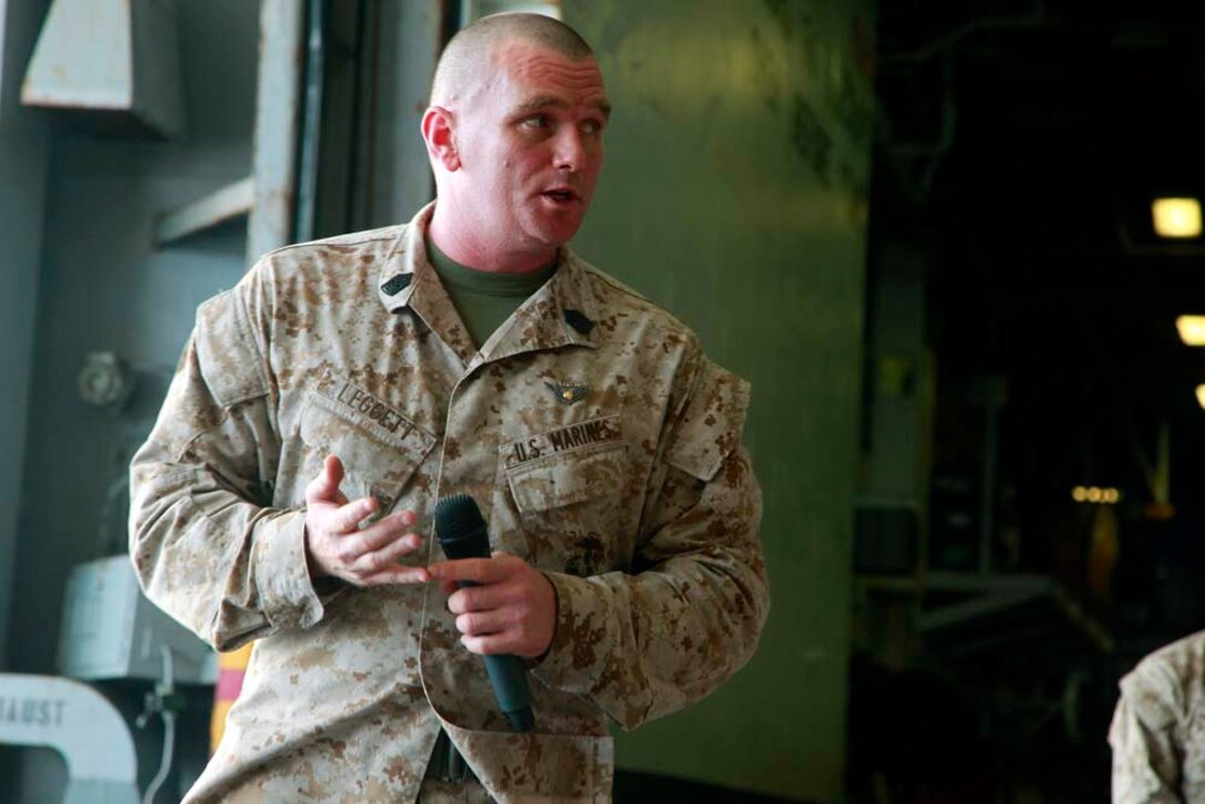 Sergeant Maj. Derek D. Leggett, sergeant major, Marine Medium Helicopter Squadron 364 (Rein.), 15th Marine Expeditionary Unit, addresses his unit after a squadron promotion and awards ceremony in the hangar bay of the USS Peleliu, Dec. 1. Marine Medium Helicopter Squadron 364 (Rein.) serves as the aviation combat element for the 15th MEU. The 15th MEU is deployed as part of the Peleliu Amphibious Ready Group as a U.S. Central Command theater reserve force, providing support for maritime security operations and theater security cooperation efforts in the U.S. 5th Fleet area of responsibility. (U.S. Marine Corps photo by Cpl. John Robbart III/Released)