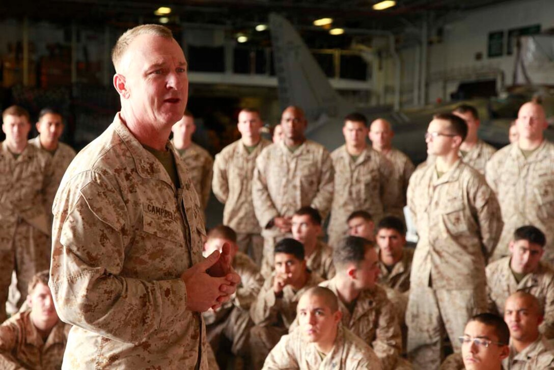 Colonel Scott D. Campbell, commanding officer, 15th Marine Expeditionary Unit, addresses his unit after the Command Element's promotion and awards ceremony in the hangar bay of the USS Peleliu, Dec. 1. The 15th MEU is deployed as part of the Peleliu Amphibious Ready Group as a U.S. Central Command theater reserve force, providing support for maritime security operations and theater security cooperation efforts in the U.S. 5th Fleet area of responsibility. (U.S. Marine Corps photo by Cpl. John Robbart III/Released)