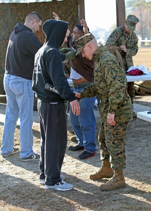 Cpl. Denis E. Thompson, an Annville, Pa. native and field mess non-commissioned officer in charge, searches for contraband on a Marine role player. Marines and sailors with 2nd Battalion, 2nd Marine Regiment, 2nd Marine Division, participate in their first field exercise in preparation for the upcoming Black Sea Rotational Force deployment.
