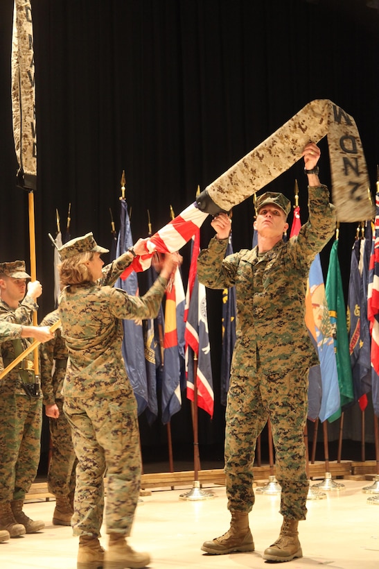 Brig. Gen. Gary L. Thomas, commanding general of 2nd Marine Aircraft Wing (Forward), and Sgt. Maj. Lisa Nilsson, sergeant major of 2nd MAW (Fwd.), uncase the wing’s colors, signifying the official activation of the unit  during a ceremony at Cherry Point Nov. 30. The unit’s mission while deployed is to provide responsive air support to II Marine Expeditionary Force (Forward).