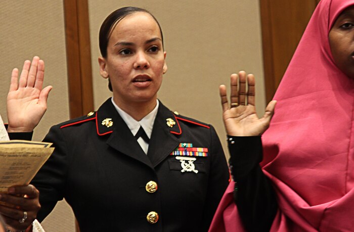 Sgt. Sonya E. Bryant, adjutant clerk at the 9th Marine Corps District, takes the Oath of Allegiance during a Naturalization Ceremony at the United States Courts, Western District of Missouri, in Kansas City, Mo., Dec. 6. Bryant immigrated from Dominican Republic at age 11 and has served in the Marine Corps for more than 9 years.