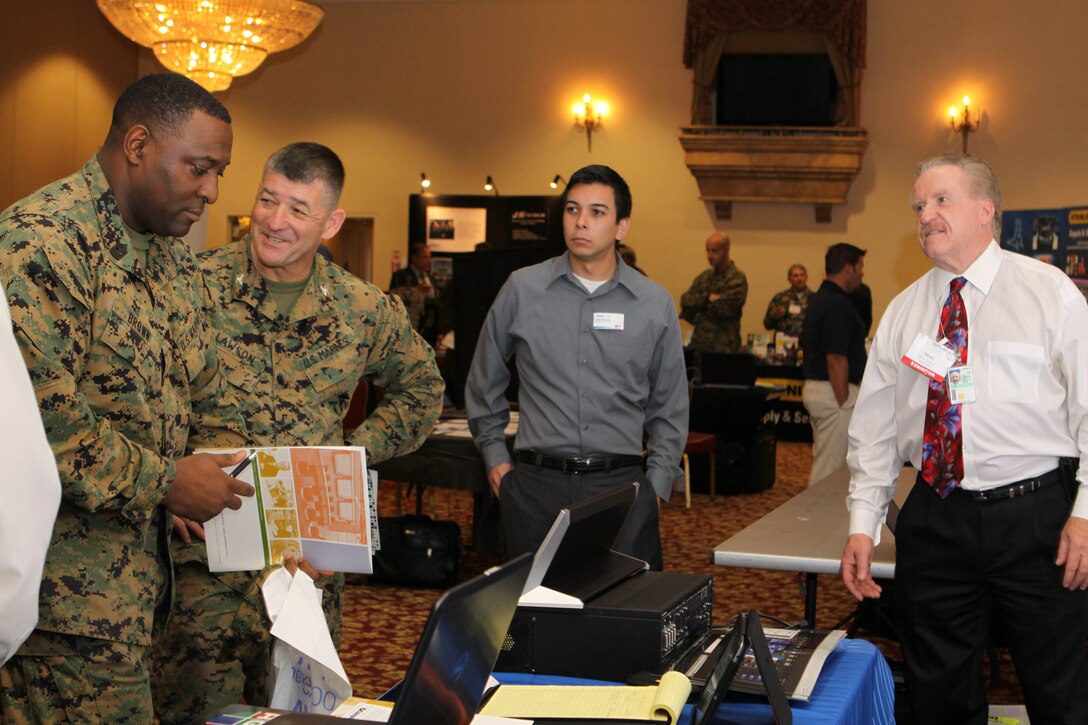 Master Gunnery Sgt. Antoine M. Brown, the communications chief for 1st Marine Logistics Group, and Col. Randy J. Lawson, chief of staff for 1st MLG, seek knowledge on some of the world’s latest technology during the semi-annual Technology Expo at the Pacific Views Event Center here, Dec. 6.