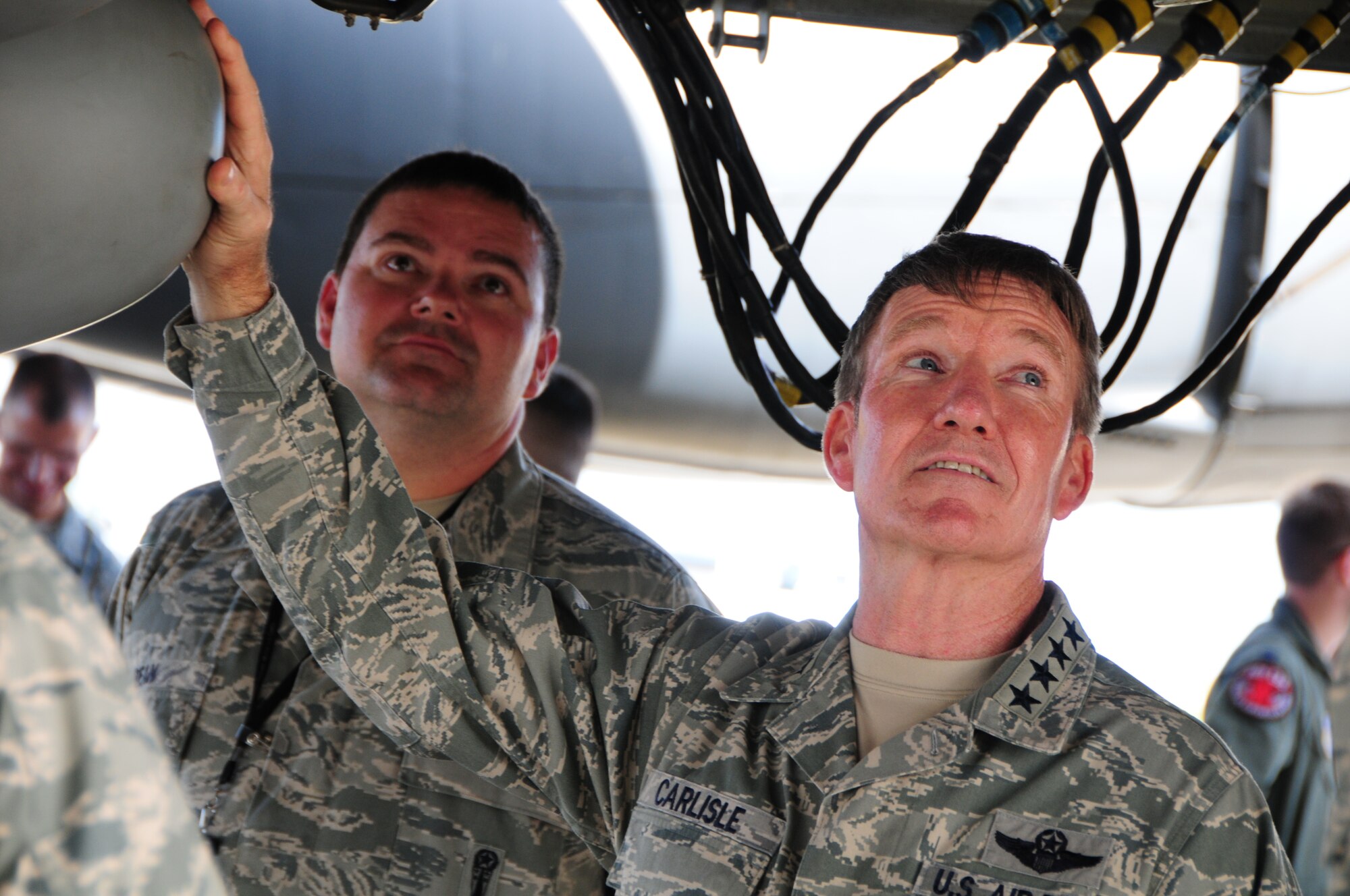 Gen. Herbert “Hawk” Carlisle, Pacific Air Forces commander, watches an AGM-86C Conventional Air-Launched Cruise Missile being loaded onto a B-52 Stratofortress on the flightline at Andersen Air Force Base, Guam, Dec. 3, 2012. The load demonstration was to show the general how fast 36th Expeditionary Aircraft Maintenance Squadron Airmen can load weapons on a B-52 Stratofortress.  (U.S. Air Force photo by Airman 1st Class Marianique Santos/Released)