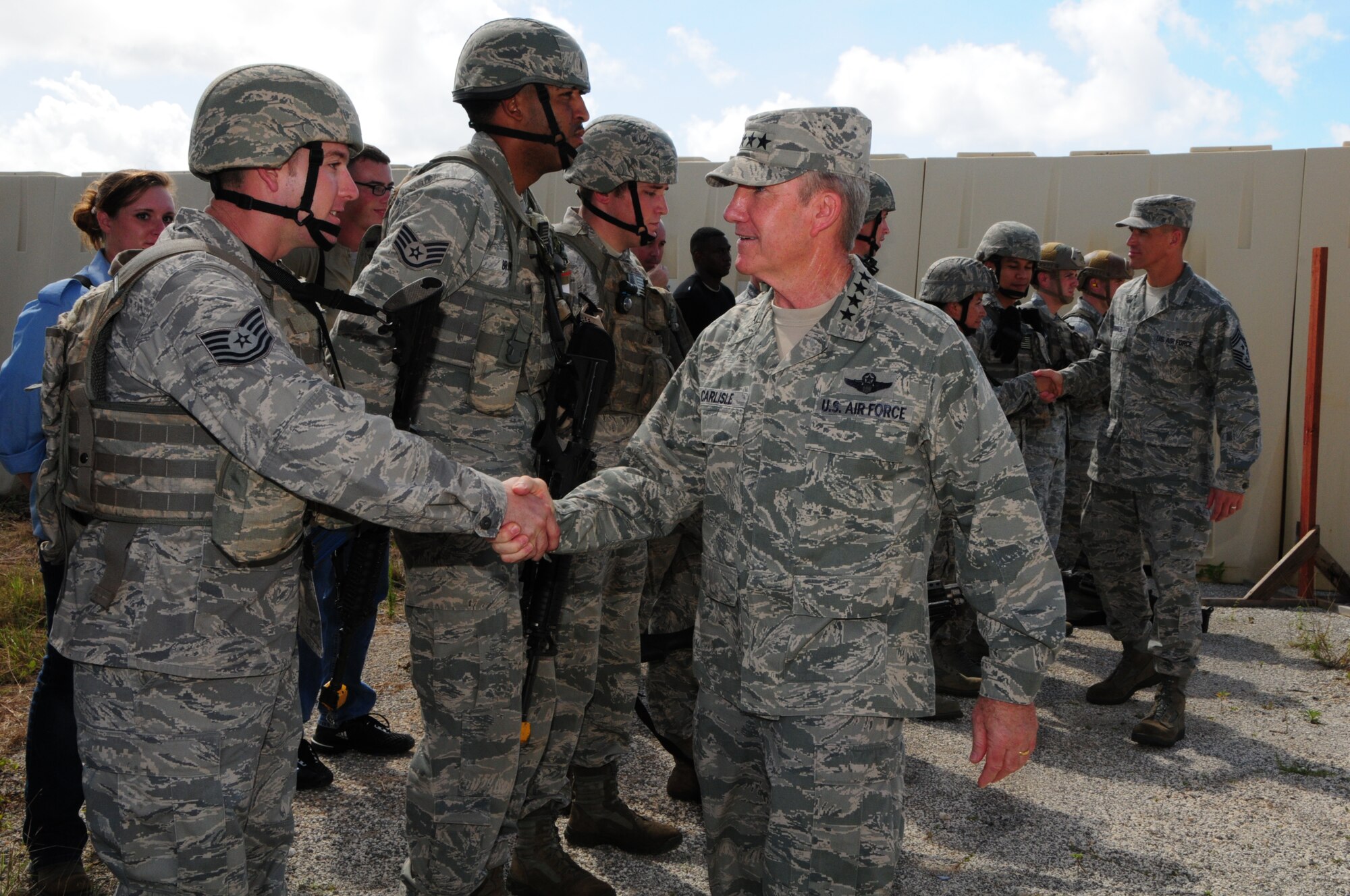 Gen. Herbert “Hawk” Carlisle, Pacific Air Forces commander shakes hands with Tech. Sgt. Jeremy Graves, 736th Security Forces Squadron Pacific Regional Training Center instructor team leader, during a visit to Northwest Field, Guam, Dec. 3, 2012.  Airmen from the 36th Contingency Response Group showed General Carlisle the different contingency capabilities that Andersen offers the Asia-Pacific region.  (U.S. Air Force photo by Airman 1st Class Marianique Santos/Released)