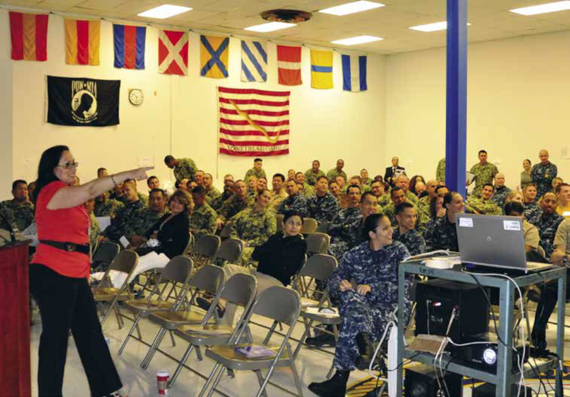 Yellow Ribbon Reintegration Program Specialist Roxanna Carrillo discusses information regarding the Yellow Ribbon program with Navy members preparing to deploy. Information was shared and briefings were given during the day-long event held at the Naval Operational Support Center, Dec. 1. (U.S. Air Force photo by Staff. Sgt. Joe Davidson)