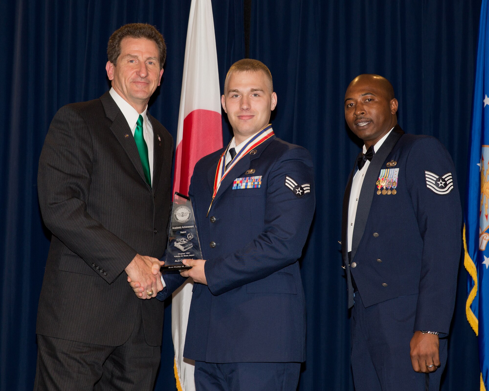 YOKOTA AIR BASE, Japan -- Senior Airman Phillip Hageberg (center), 730th Air Mobility Squadron, received the Academic achievement Award during the Airman Leadership School Class 13-A graduation ceremony at Yokota Air Base, Japan, Dec. 6, 2012. Retired Chief Master Sgt. Steve Wright (left) and Tech. Sgt. Brandon Johnson (right), Det. 402, representatives of the Air Force Sergeants Association, presented the award to Hageberg during the ceremony. (U.S. Air Force photo by Osakabe Yasuo) 
