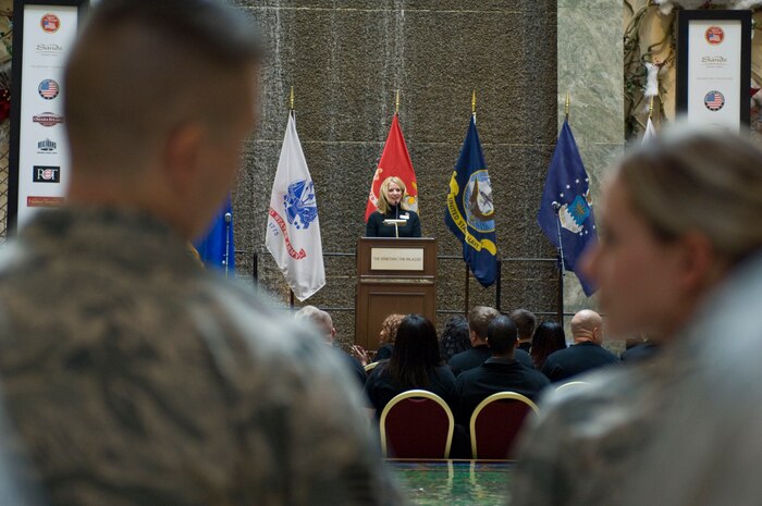 Airmen from Nellis Air Force Base listen to Jo Lynn Scott, the master of ceremony, during a "Salute Our Troops" celebration Dec. 5, 2012, in Las Vegas. This semi-annual event highlights service members who have been severely injured while serving overseas. (U.S. Air Force photo by Airman 1st Class Monet Villacorte)