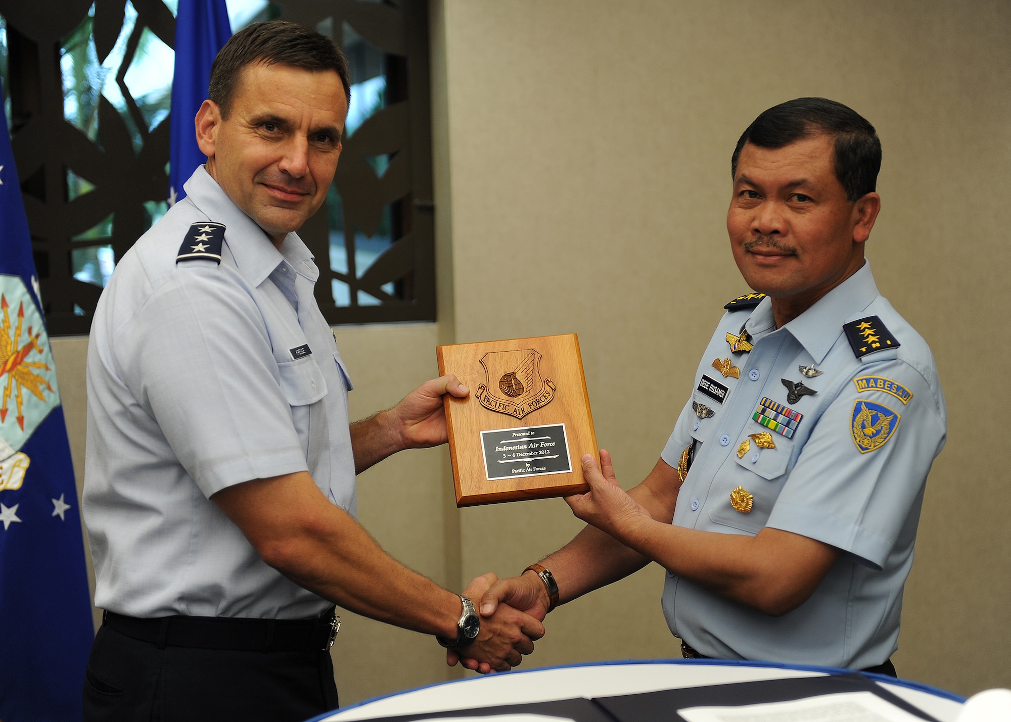 Lt. Gen. Ted Kresge, vice commander, Pacific Air Forces  presents a plaque to Air Marshal Ded Rusamsi, Vice Chief (Wakasau) of Staff Indonesian Air Force (right), at the conclusion of the sixth United States and Indonesian Airman-to-Airman Talks here at PACAF headquarters, Joint Base Pearl Harbor-Hickam, Hawaii, Dec. 5, 2012. The Airman-to-Airman talks are designed to foster military-to-military relationships with an allied force and to renew long-standing partnerships. (U.S. Air Force photo/Staff Sgt. Matthew S. Bright/Released)