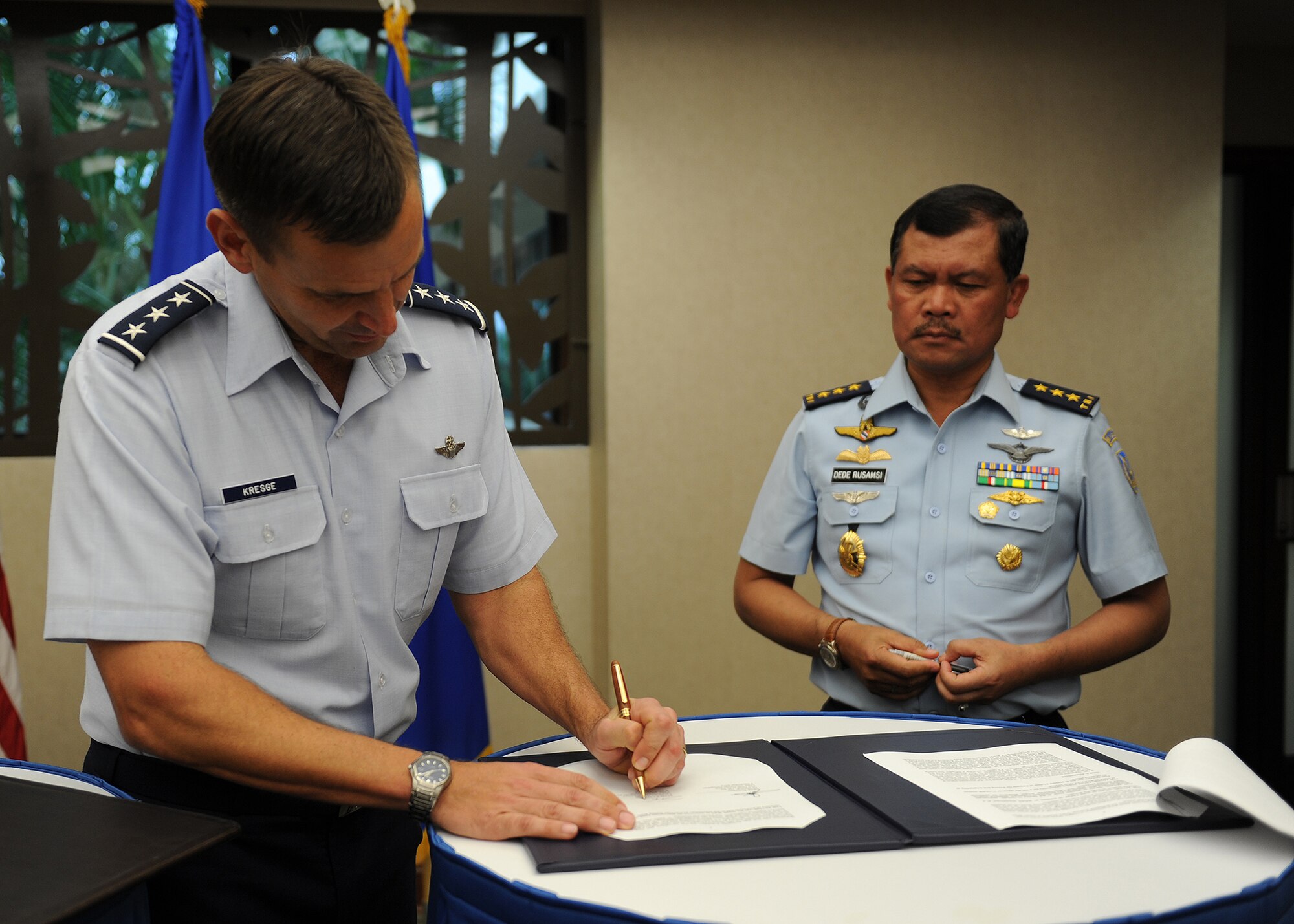 Lt. Gen. Ted Kresge, vice commander, Pacific Air Forces, and Air Marshal Ded Rusamsi, Vice Chief (Wakasau) of Staff Indonesian Air Force (right), sign meeting minutes at the conclusion of the sixth annual United States and Indonesian Airman-to-Airman talks here at Joint Base Pearl Harbor-Hickam, Hawaii, Dec. 5, 2012. The talks are air force specific and include dialogue for regional security cooperation in air and space operations. (U.S. Air Force photo/Staff Sgt. Matthew S. Bright/Released)