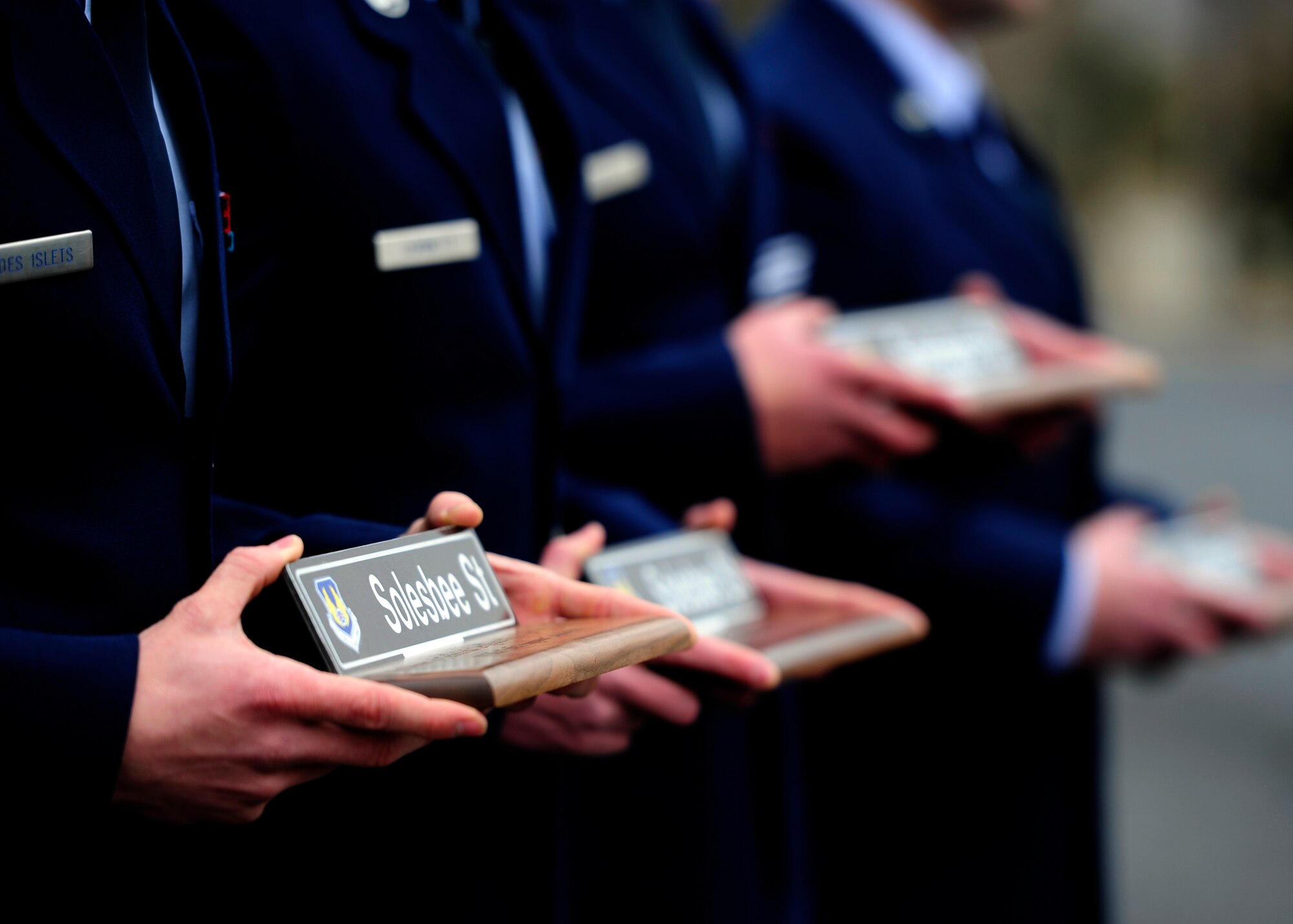 Airmen stand ready to present plaques to the family members of Tech. Sgt. Kristoffer M. Solesbee, a Hill AFB EOD technician, during a Dec. 4 street renaming ceremony. The installation's 12th Street was renamed in honor of Solesbee who lost his life in Afghanistan in May 2011. (U.S. Air Force photo/Airman 1st Class Justyn Freeman)