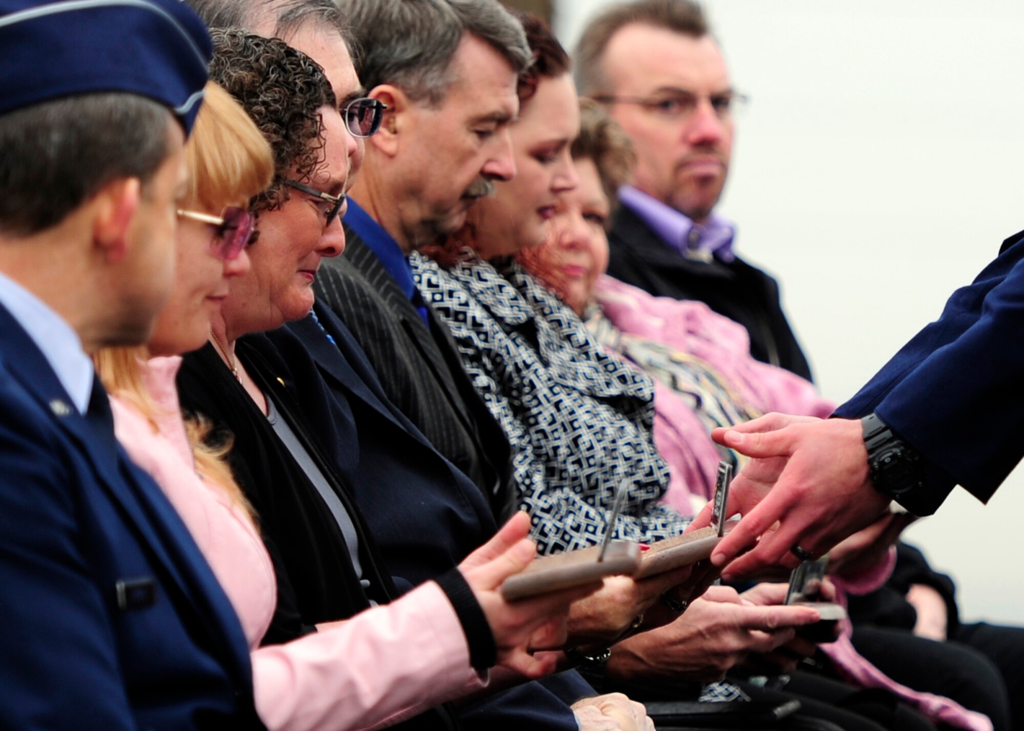 Family members of Tech. Sgt. Kristoffer M. Solesbee, a Hill AFB EOD technician, accept plaques in his honor during a Dec. 4 street renaming ceremony. The installation's 12th Street was renamed to Solesbee Street and the plaques are similar to the new Solesbee Street sign. Solesbee lost his life in Afghanistan in May 2011. (U.S. Air Force photo/Airman 1st Class Justyn Freeman)
