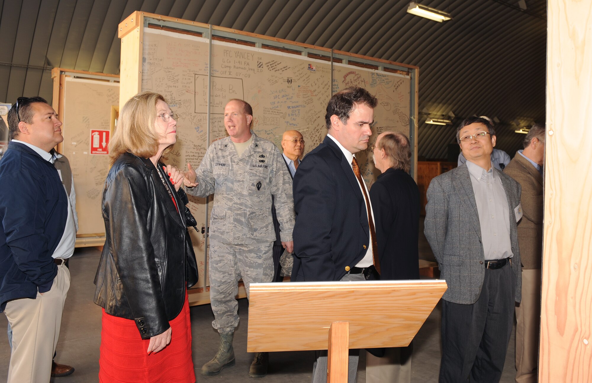 U.S. Air Force Col. Robert Lepper, 309th Aerospace Maintenance and Regeneration Group commander, explains the significance of the 'Walls of Balad' to a group of honorary commanders as part of an AMARG tour on Davis-Monthan Air Force Base, Ariz., Dec. 5, 2012. The 'Walls of Balad' were the recreation room walls of the Contingency Aeromedical Staging Facility at Joint Base Balad in Iraq. Patients, whether civilian or service members, were encouraged to write their prayers, thoughts and feelings on the walls, while they awaited transport to Landstuhl Regional Medical Center in Germany. (U.S. Air Force photo by Senior Airman Brittany Dowdle) 