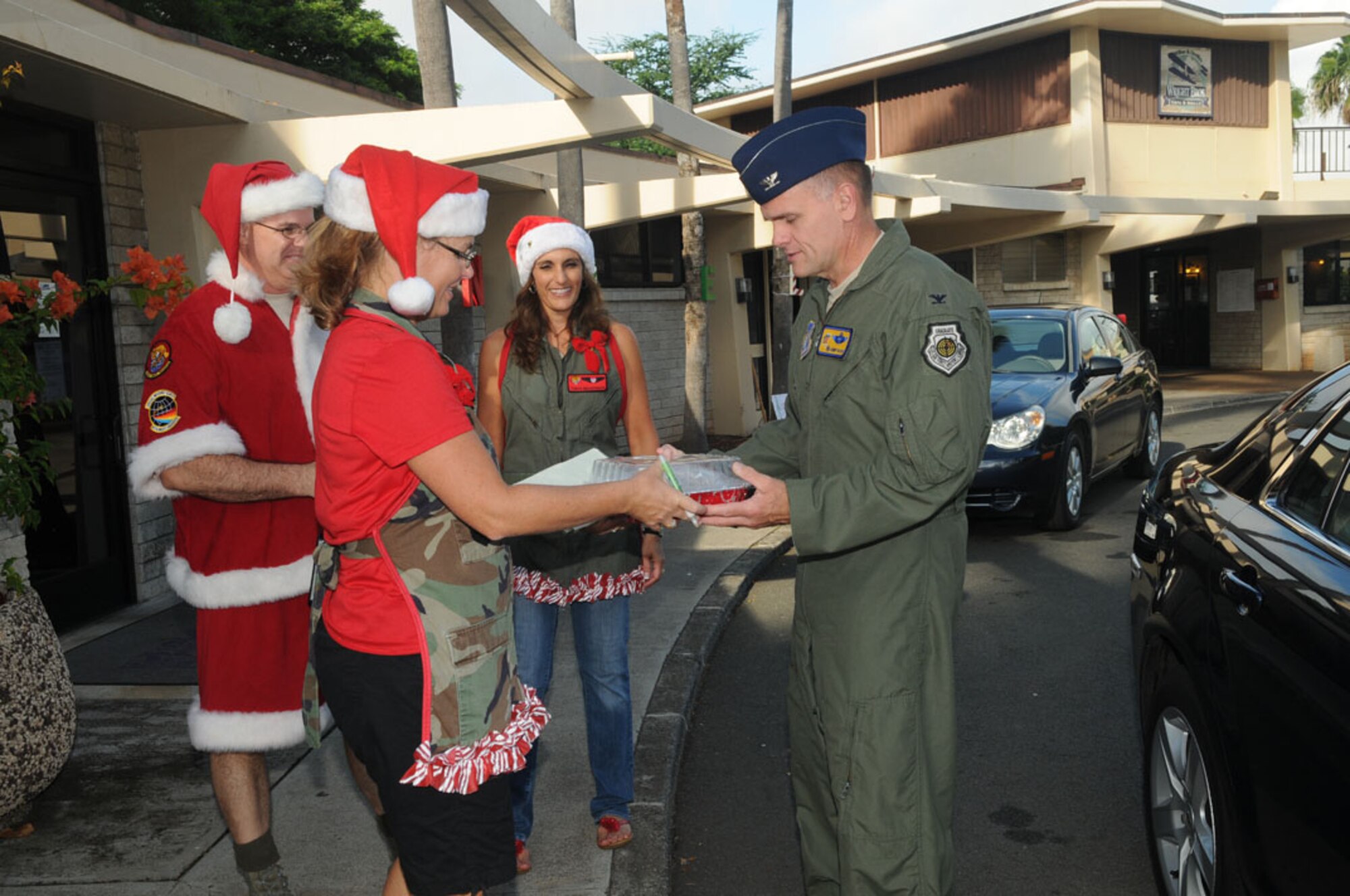 Col. Johnny Roscoe, Commander, 15th Wing, delivers cookies to
Angela Bennett, military spouse, for the 15th Wing Cookie Caper near the
Wright Brother's Cafe on Joint Base Pearl Harbor-Hickam, Hawaii, 4 Dec 2012.
The event is hosted by the 15th Operations Group, and cookie donations are
being collected to send to deployed Airmen this holiday season.  Photo by
David D. Underwood, Jr.
