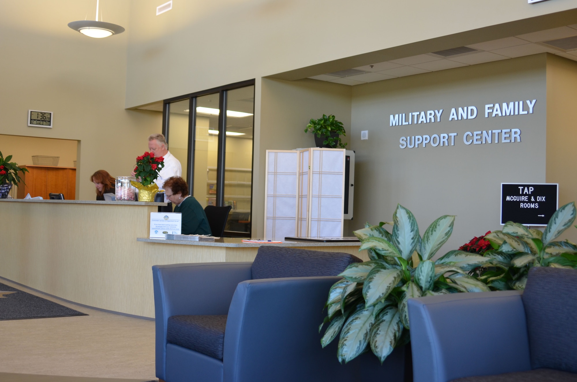 The staff of the new 18,000-square-foot Military and Family Support Center prepares the reception area for the ribbon cutting ceremony today. The facility is fully furnished and equipped to provide support to service members and families. (U.S. Air Force photo by Kim Wright/Released)
