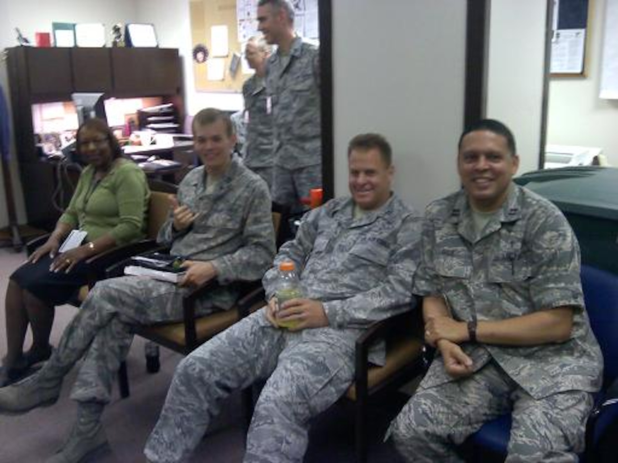 Chaplain (Capt.) Gabriel Rios, 325th Fighter Wing senior faith Protestant chaplain (far right), sits with Airmen during a duty day. (Courtesy photo)