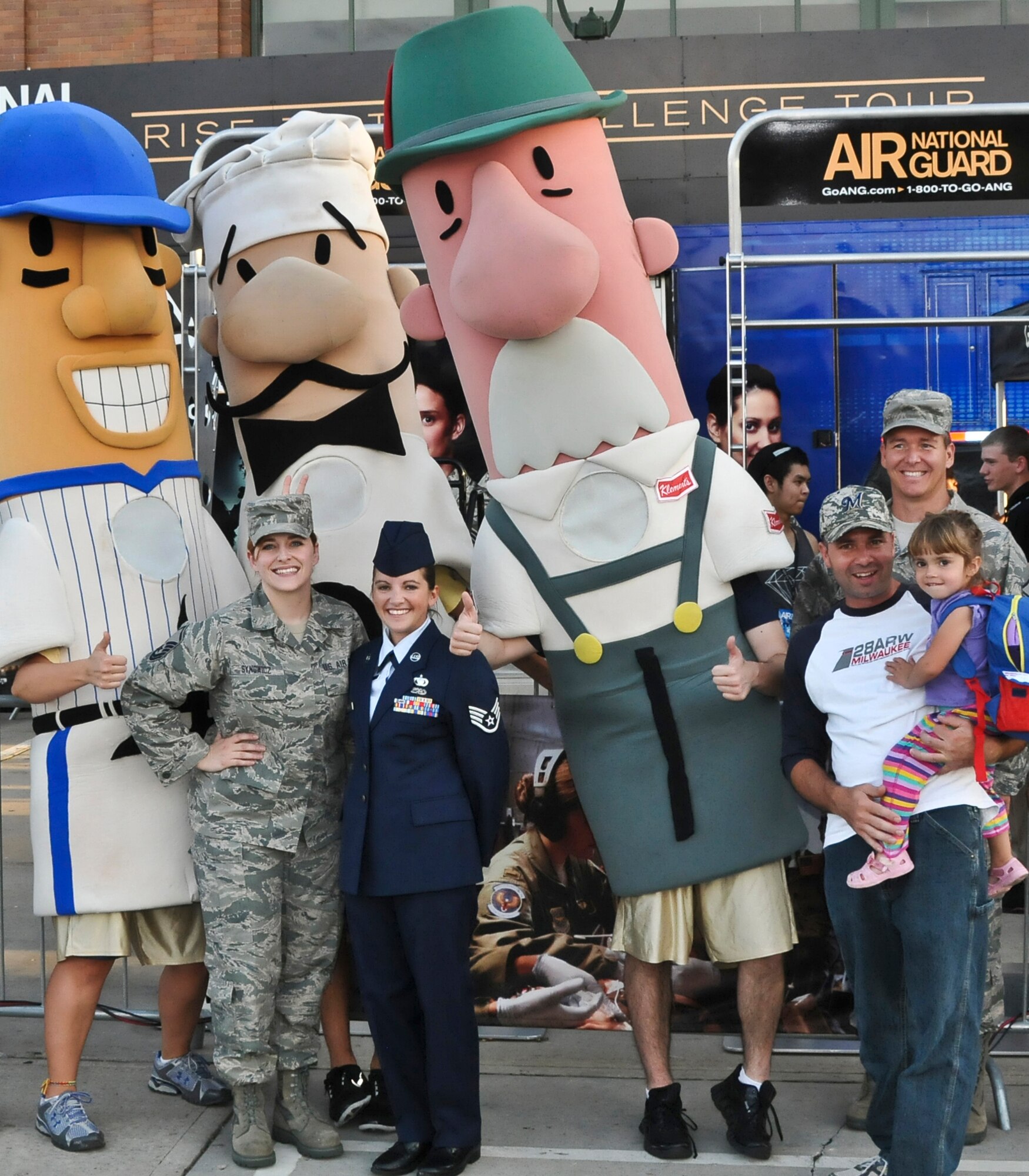 (Left to Right) Master Sgt. Nikki Synowicz, Staff Sgt. Leah Rogers, Tech. Sgt. Chris Rogers (in civilian clothes, holding child) and Master Sgt. Robert Van Lanen meet the Milwaukee Brewers’ Famous Racing Sausages at the Air National Guard’s recruiting booth at Miller Park in Milwaukee Wed., Sept. 12, 2012.
(Air National Guard Photo by Staff Sgt. Jeremy M. Wilson / Released)
