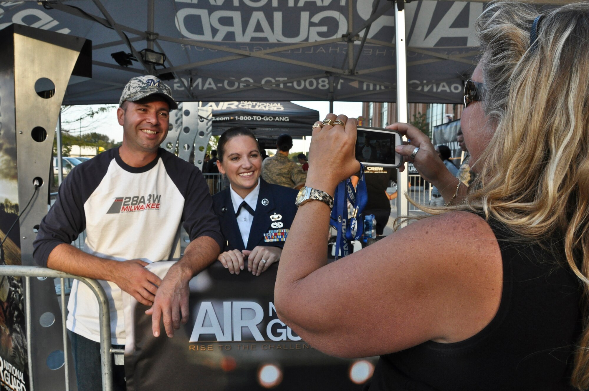 Wisconsin Air National Guardsman Staff Sgt. Leah Rogers and her husband, Chris, pose for a photograph at the Air National Guard’s recruiting booth at Miller Park in Milwaukee Wed., Sept. 12, 2012. 
Chris Rogers also serves with the 128th as Quality Assurance Inspector in the Maintenance Squadron and holds the rank of technical sergeant. 
Rogers was at Miller Park to throw out the ceremonial first pitch before the Brewers’ game against the Atlanta Braves. (Air National Guard Photo by Staff Sgt. Christopher Wenzel / Released)
