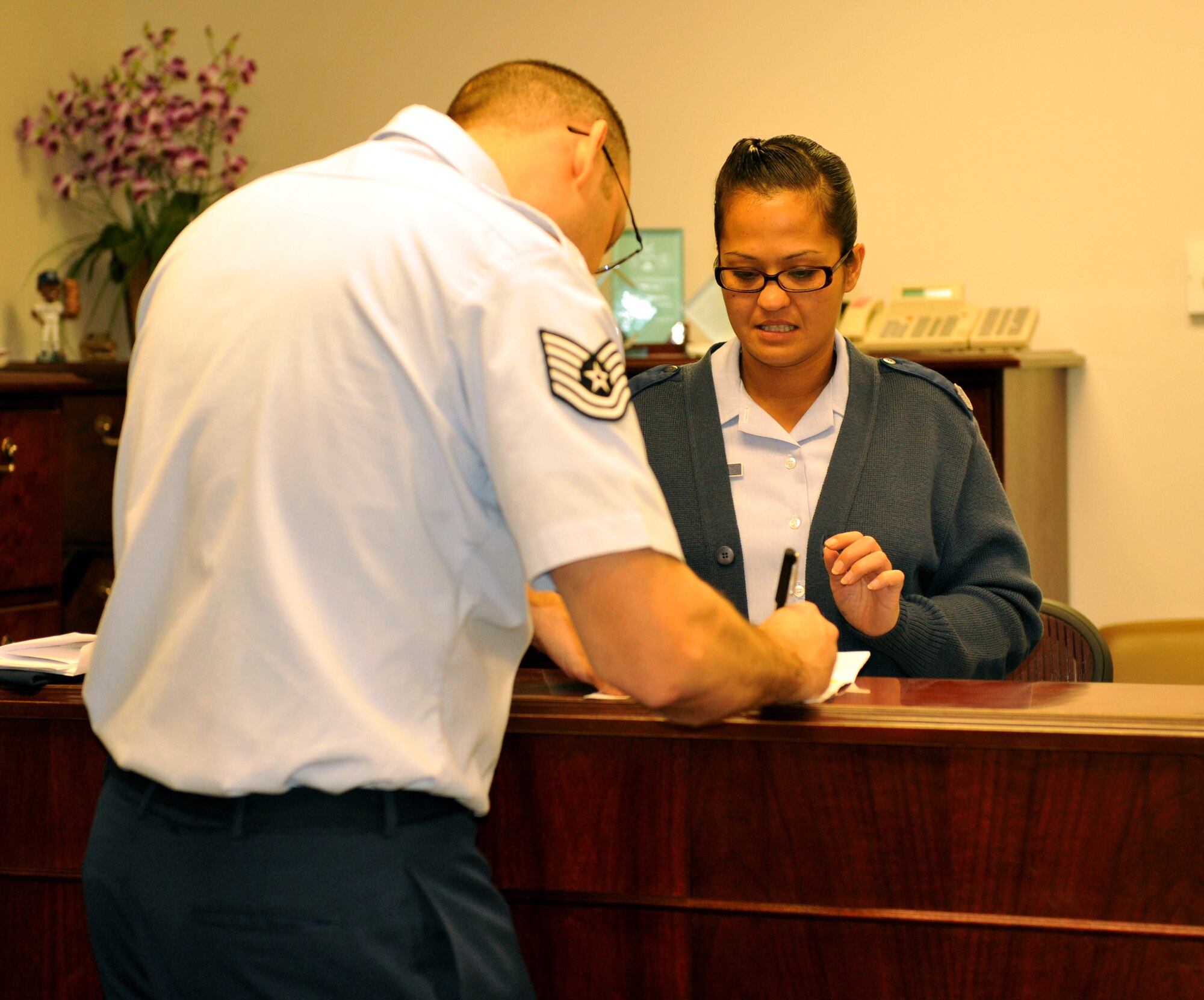 Master Sgt. Mary Madison, 509th Bomb Wing Law Office superintendent, assists a customer during her shift at the 509th BW Legal Office Dec. 3 at Whiteman Air Force Base, Mo. The 509th Bomb Wing’s Legal Office was named the 2012 Air Force Global Strike Command’s Base Legal Office of the Year. (U.S. Air Force photo/Heidi Hunt)