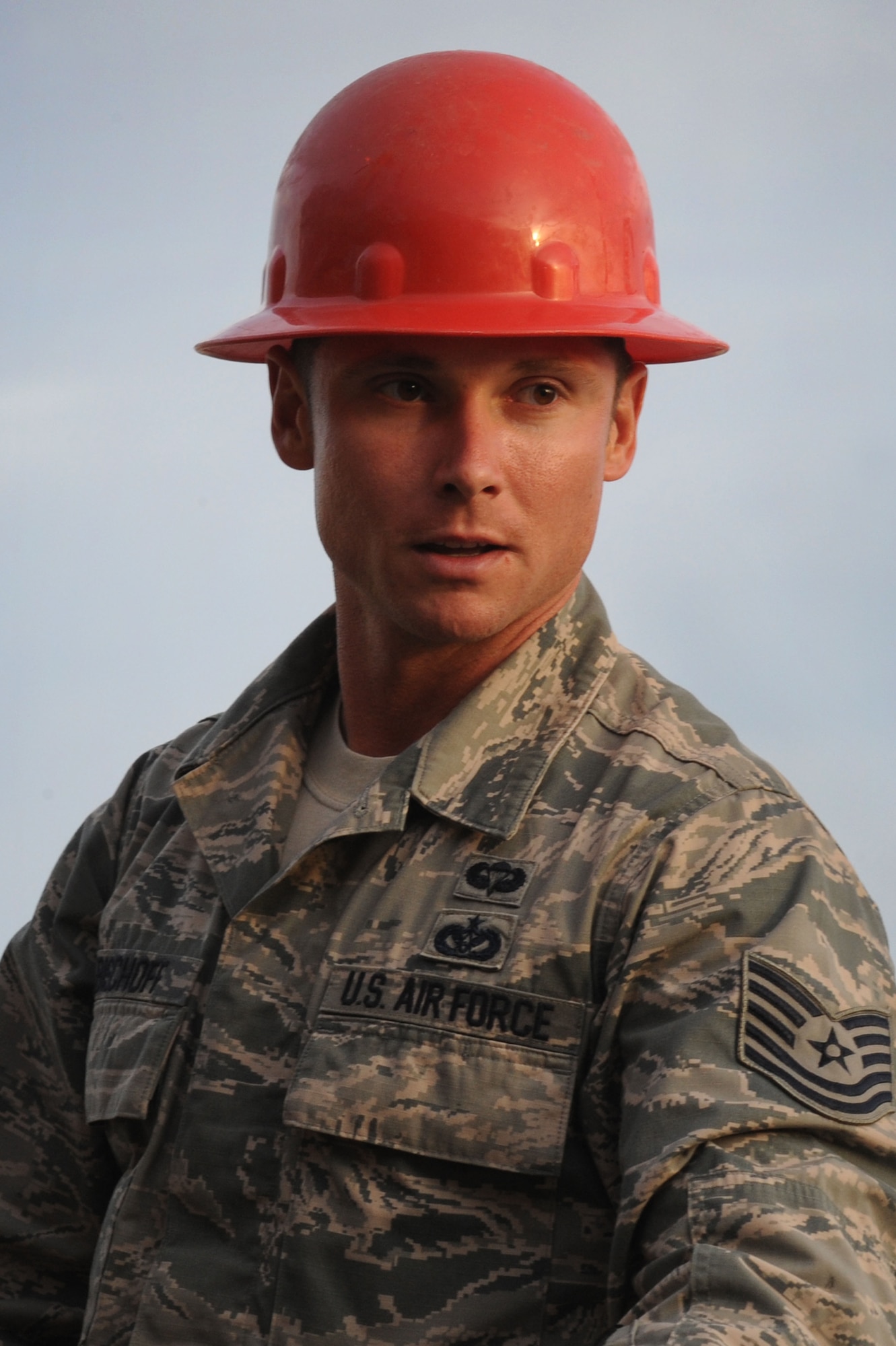 Tech. Sgt. Jason Bischoff, 820th RED HORSE Squadron airborne pavement and equipment operator, communicates with other crew members to remove heavy equipment from a Tunner 60K aircraft loader Nov. 29, 2012, at Nellis Air Force Base, Nev. RED HORSE provides rapid response using the most expedient methods of travel available: airdrop from fixed or rotary-wing aircraft, insert via rotary-wing aircraft, standard airlift and convoy. (U.S. Air Force photo by Staff Sgt. William P. Coleman)