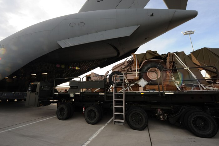 A backhoe from the 820th RED HORSE Squadron is loaded onto a C-17 Globemaster III Nov. 29, 2012, at Nellis Air Force Base, Nev. Airmen from the 820th RED HORSE Squadron are capable of parachuting into heavily damaged airfields and rapidly repairing them for safe aircraft landings. (U.S. Air Force photo by Staff Sgt. William P. Coleman)