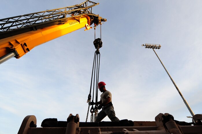 U.S. Air Force Staff Sgt. Armando Irizarry, 820th RED HORSE Squadron airborne electronic systems craftsman, disconnects a crane from heavy equipment Nov. 29, 2012, at Nellis Air Force Base, Nev. The 820th RED HORSE is the only Air Force civil engineer unit with Airborne and Air Assault qualified engineer capabilities with equipment and personnel rigging support, including Explosive Ordnance Disposal, Emergency Management and Fire/Emergency Services personnel. 
(U.S. Air Force photo by Staff Sgt. William P. Coleman)
