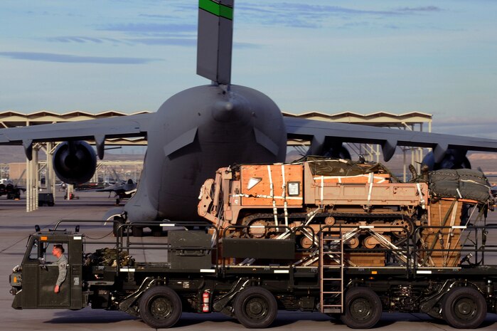 U.S. Air Force Staff Sgt. Robert DeSanto, 571st Global Mobility Squadron aerial port supervisor from Travis Air Force Base, Calif., drives a Tunner 60K aircraft loader carrying a track dump Nov. 29, 2012, at Nellis Air Force Base, Nev. The mission of the 571st GMS is to rapidly deploy elite mobility teams to provide air mobility infrastructure to meet America's objectives anywhere in the world. (U.S. Air Force photo by Staff Sgt. William P. Coleman)