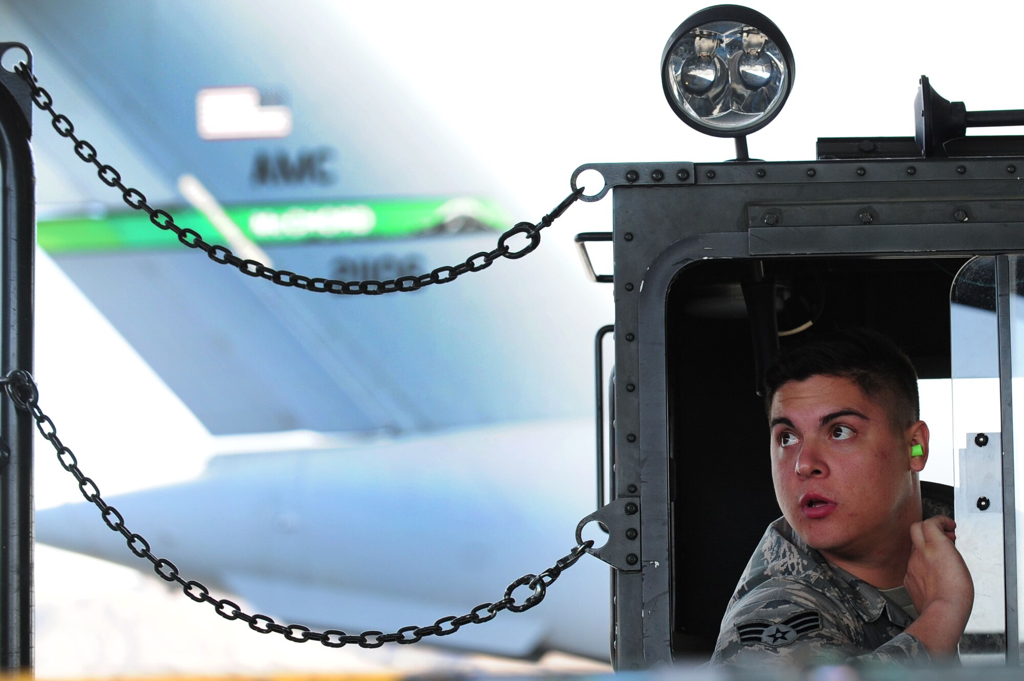 Senior Airman Michael Crawford, 571st Global Mobility Squadron aerial port specialist from Travis Air Force Base, Calif., operates a Tunner 60K aircraft loader to load construction equipment on a C-17 Globemaster III Nov. 29, 2012, at Nellis Air Force Base, Nev. The Tunner 60K aircraft loader is a highly mobile vehicle system that can transport up to six pallets of cargo at a maximum speed of 23 miles per hour. (U.S. Air Force photo by Staff Sgt. William P. Coleman)