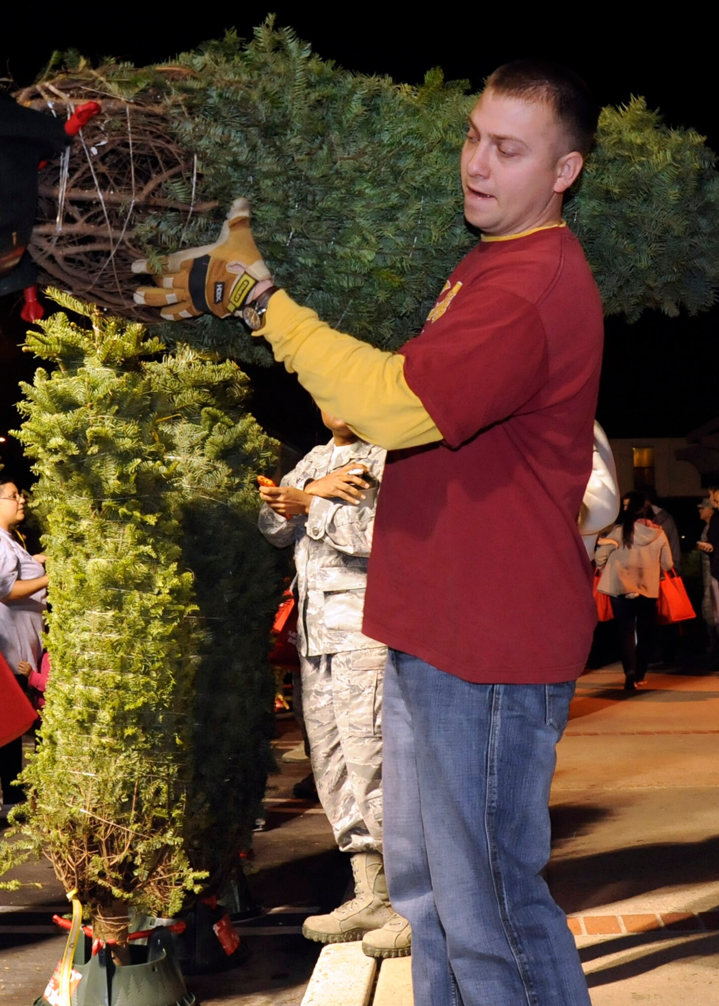 LOMPOC, Calif. – Volunteers from base and the surrounding area help families load and deliver trees to their homes during the 6th annual Trees for Troops event here Wednesday evening, Dec. 5, 2012. The event included a buffet table with hot and cold foods, speeches and tree pick-ups for deployed spouses and families in need assigned to the base. (U.S. Air Force photo/Michael Peterson)