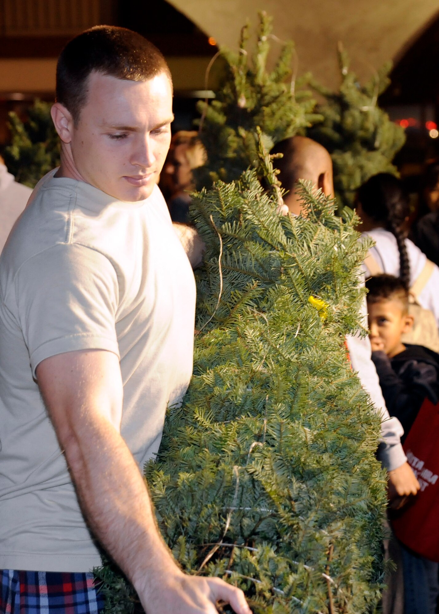 LOMPOC, Calif. – Volunteers from the surrounding area help troops load and deliver trees to their houses during the 6th annual Trees for Troops event at the Santa Barbara Bank and Trust here Wednesday, Dec. 5, 2012. This year marked the 6th annual Trees for Troops event where Santa Barbara Bank and Trust donated trees to deployed spouses and families in need assigned to the base. (U.S. Air Force photo/Michael Peterson)