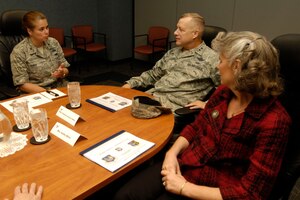 U.S. Air Force Col. Linda Curry (left), 735th Supply Chain Operations Group commander gives a mission brief to Maj. Gen. Lawrence Wells, 9th Air Force commander, and wife Kathy Wells during their visit to Langley Air Force Base, Va., Dec. 5, 2012. The general and his wife visited Langley to show appreciation to the assigned tenant units supported by the installation. (U.S. Air Force photo by Staff Sgt. Jeff Nevison/Released)