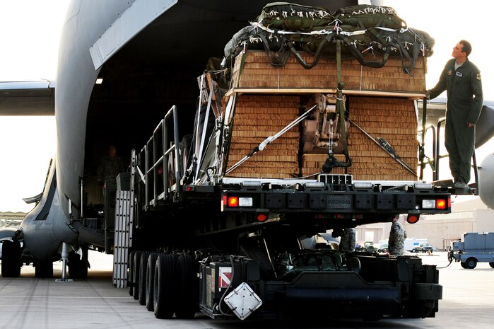 U.S. Air Force Staff Sgt. Justin Davenport, 57th Weapons Squadron loadmaster from Joint Base McGuire-Dix-Lakehurst, N.J., checks construction equipment before it is loaded into a C-17 Globemaster III Nov. 29, 2012, at Nellis Air Force Base, Nev. Cargo is loaded onto the C-17 through a large aft door that accommodates military vehicles and palletized cargo. (U.S. Air Force photo by Staff Sgt. William P. Coleman)