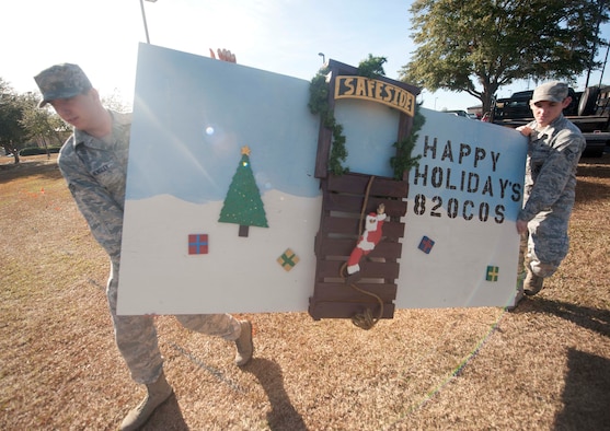 U.S. Air Force Senior Airmen Edward Young and Senior Airmen Jacob Hensley, both 820th Combat Operations Squadron security forces, set up their unit’s Christmas card at Moody Air Force Base, Ga., Dec. 5, 2012. The 820th COS picked an idea and decorated their card based on their job. (U.S. Air Force photo by Airman 1st Class Paul Francis/Released)
