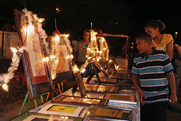 Members of Team Seymour view children’s artwork during the annual tree lighting ceremony at Seymour Johnson Air Force Base, N.C., Dec. 3, 2012. The tree lighting ceremony brings together the Seymour Johnson community to witness the lighting of the holiday tree and enjoy music, food and beverages. (U.S. Air Force photo/Airman 1st Class John Nieves Camacho/Released)