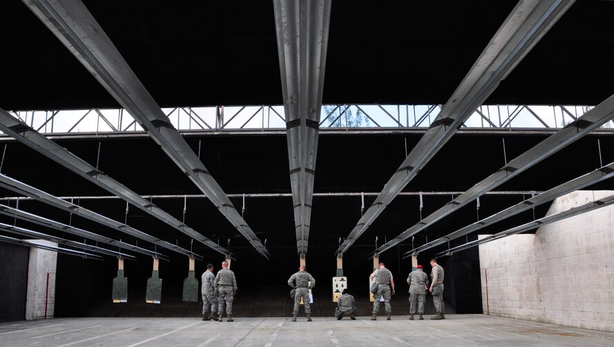 Airmen from the 70th Aerial Port Squadron review their targets during M-4 carbine qualification at Homestead Air Reserve Base’s Combat Arms Training and Maintenance range, Dec. 1. Airmen are scheduled to qualify within the 90 days prior to a deployment or annually, depending on their job, to stay within Air Force regulations. During an evaluation for the M-4, Airmen must hit the target on 17 of 24 rounds to qualify. All told, Airmen fire 192 rounds, to include both practice and evaluation rounds. (U.S. Air Force photo/Tech. Sgt. Robert Gibson)